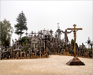 Hill of Crosses or Kryžių Kalnas, is a site of pilgrimage about 12 km north of the city of Šiauliai, in northern Lithuania. The precise origin of the practice of leaving crosses on the hill is uncertain, but it is believed that the first crosses were placed on the former Jurgaičiai or Domantai hill fort after the 1831 Uprising. Over the generations, not only crosses and crucifixes, but statues of the Virgin Mary, carvings of Lithuanian patriots and thousands of tiny effigies and rosaries have been brought here by Catholic pilgrims. The exact number of crosses is unknown, but estimates put it at about 55,000 in 1990 and 100,000 in 2006.